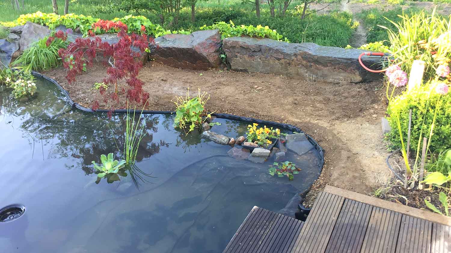 Black liner installed in natural swimming pool