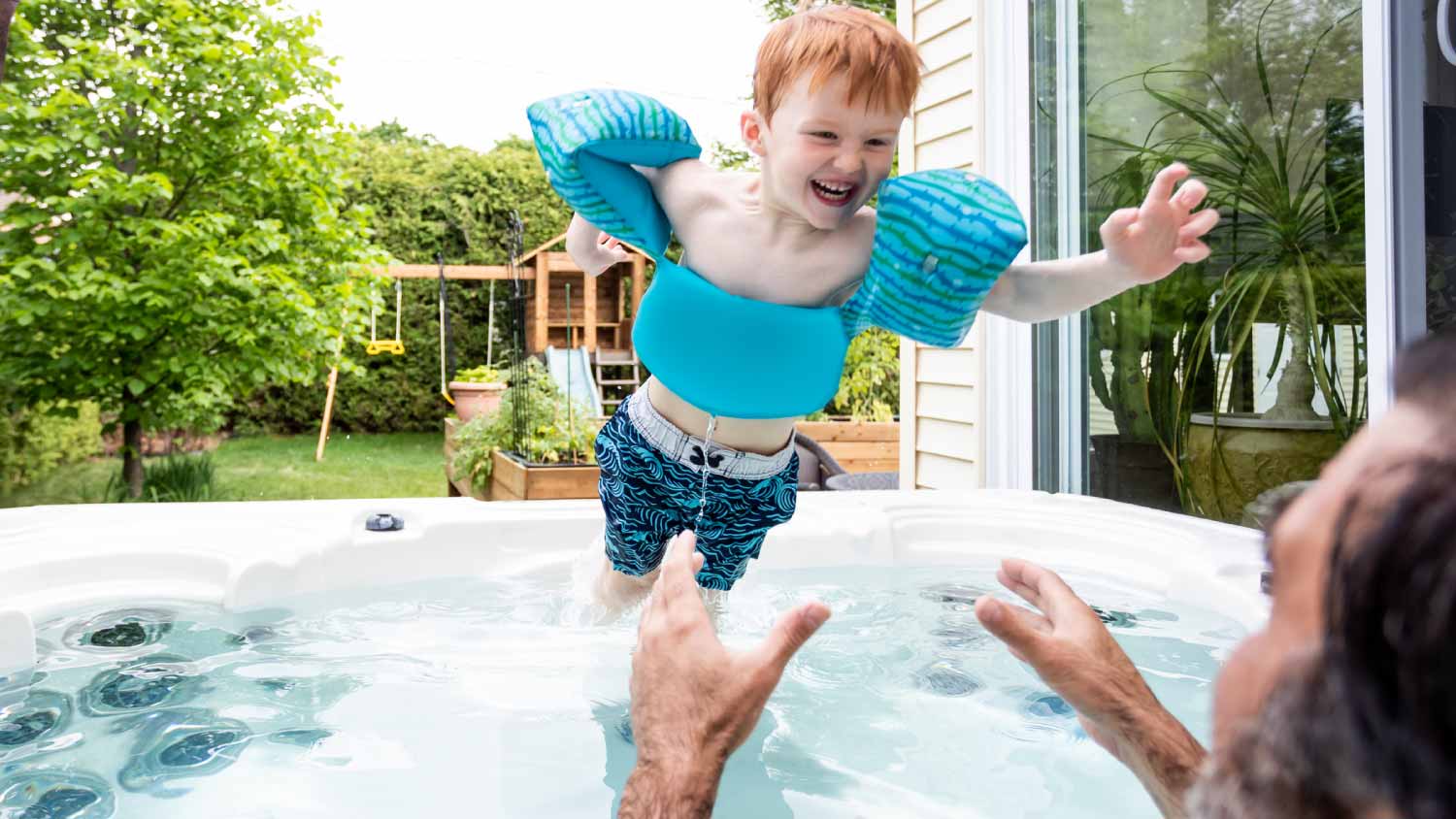 Kid and father in the hot tub