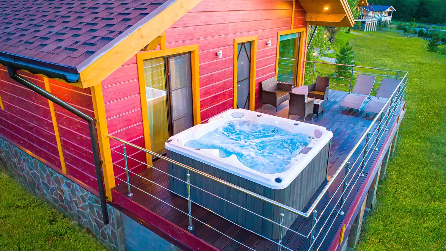 Cabin exterior with a hot tub placed on the deck