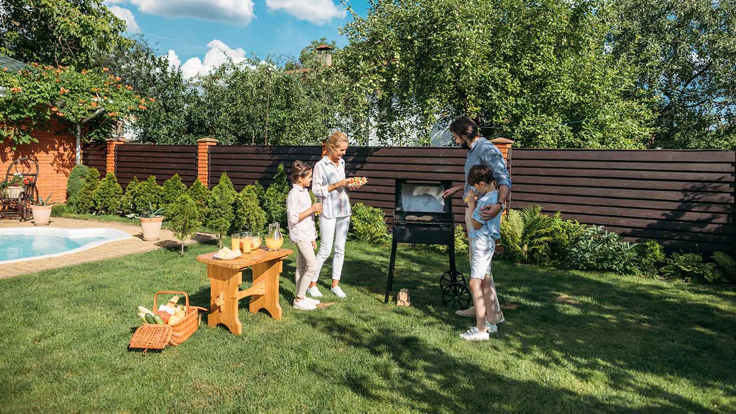 Family having barbecue in the backyard