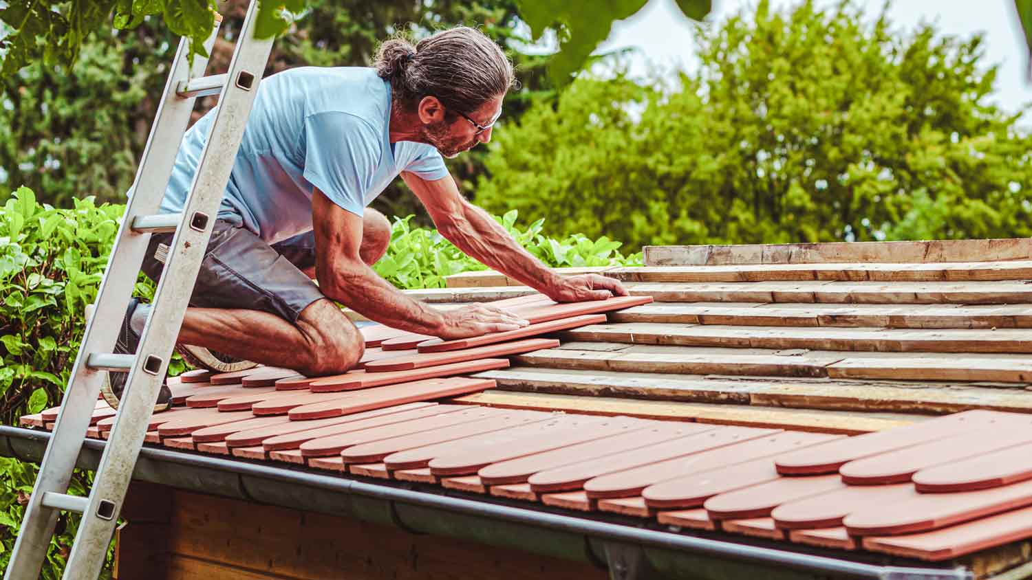 man repairing roof shed