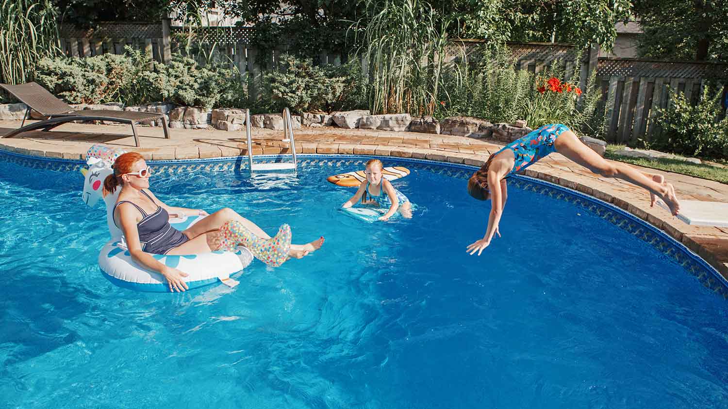 Mother and daughters having fun in the pool