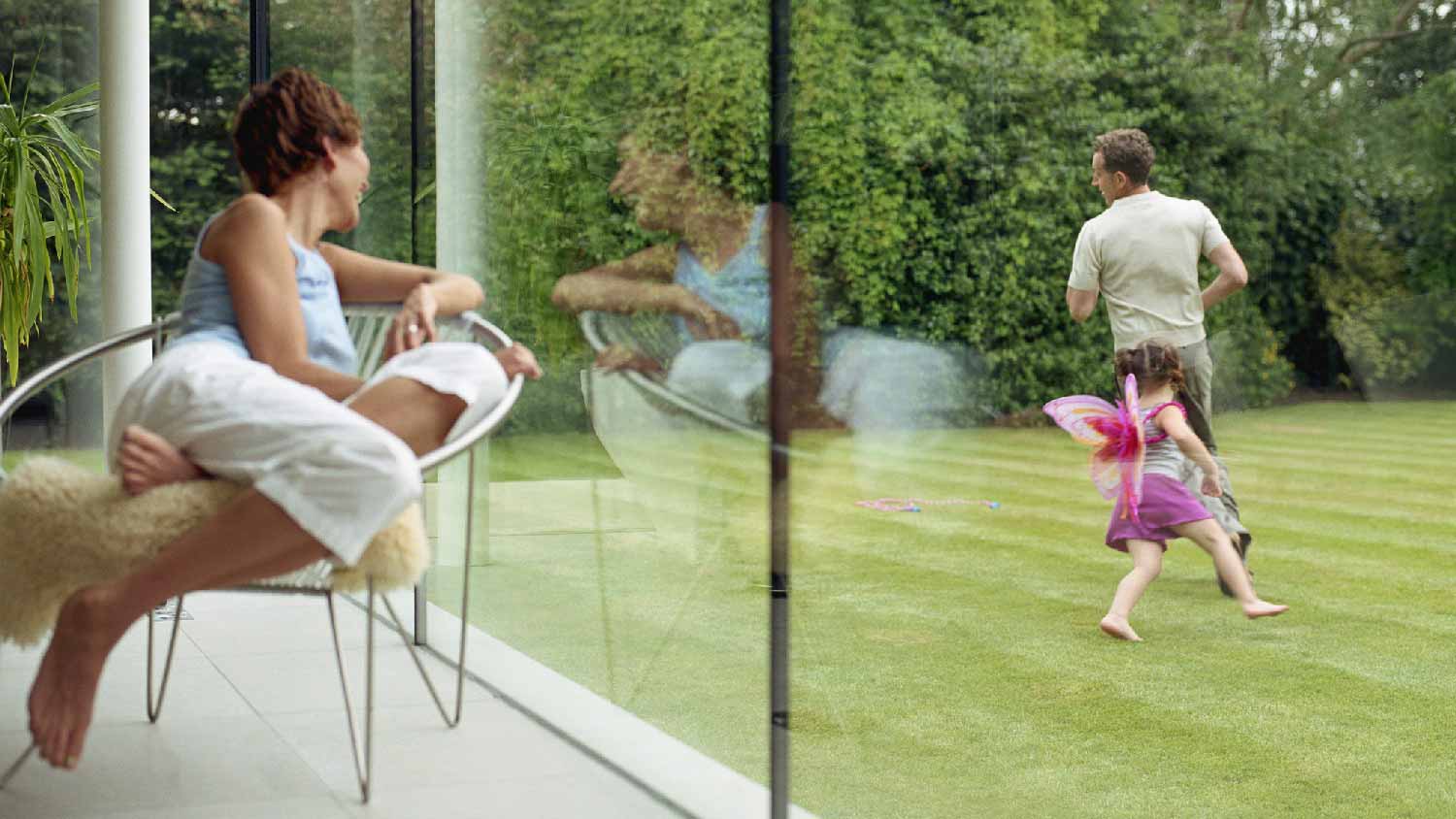 A father running with his daughter in the lawn