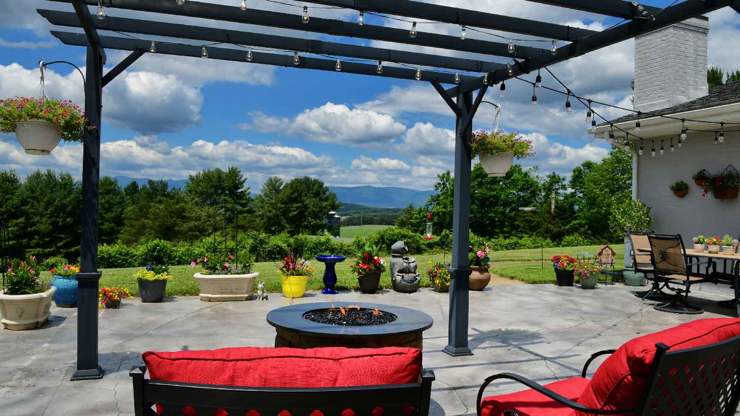 A patio with a fire pit and a pergola