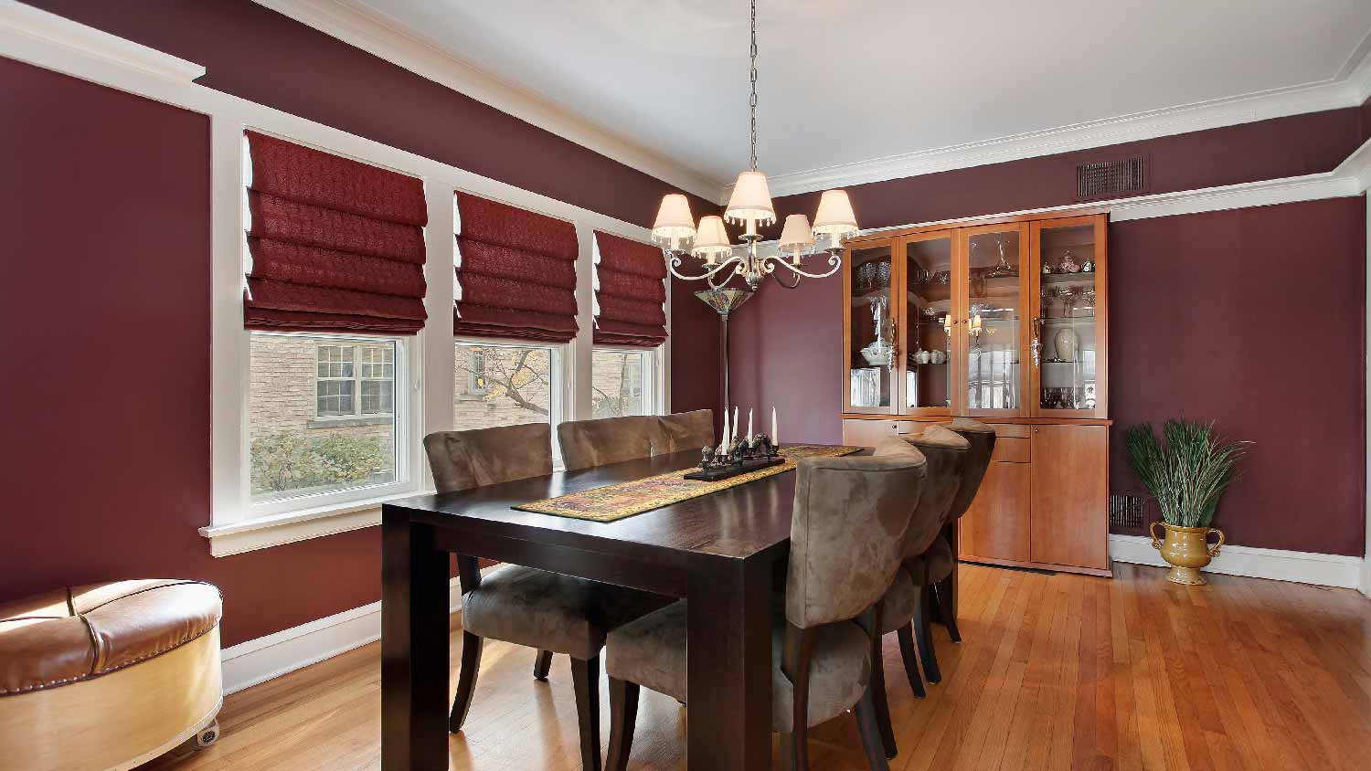 A dining room with plum walls