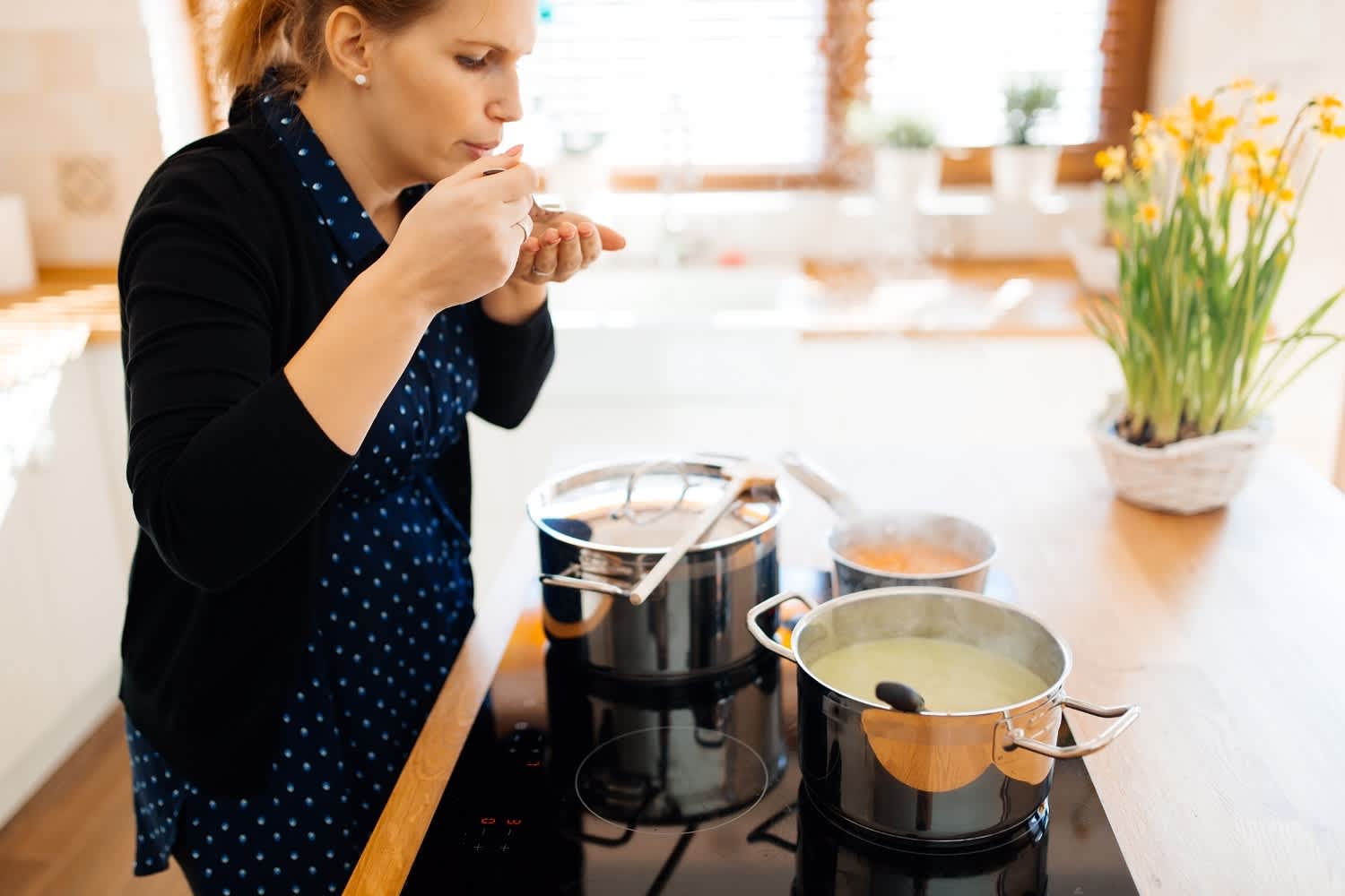 Pots steaming on electric cooktop in kitchen