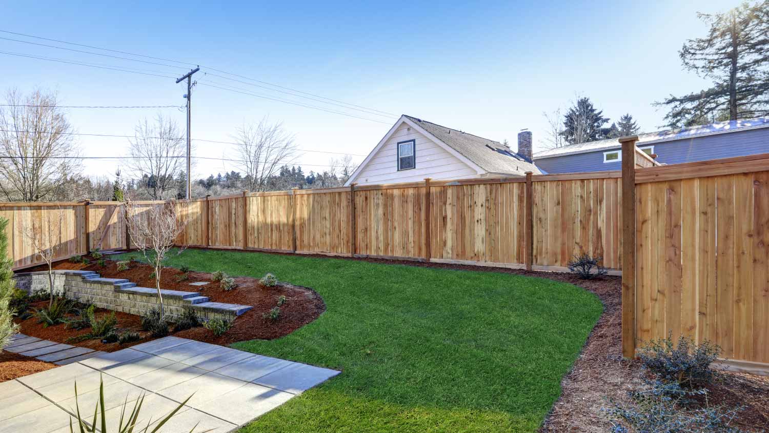 Backyard surrounded by wooden fence