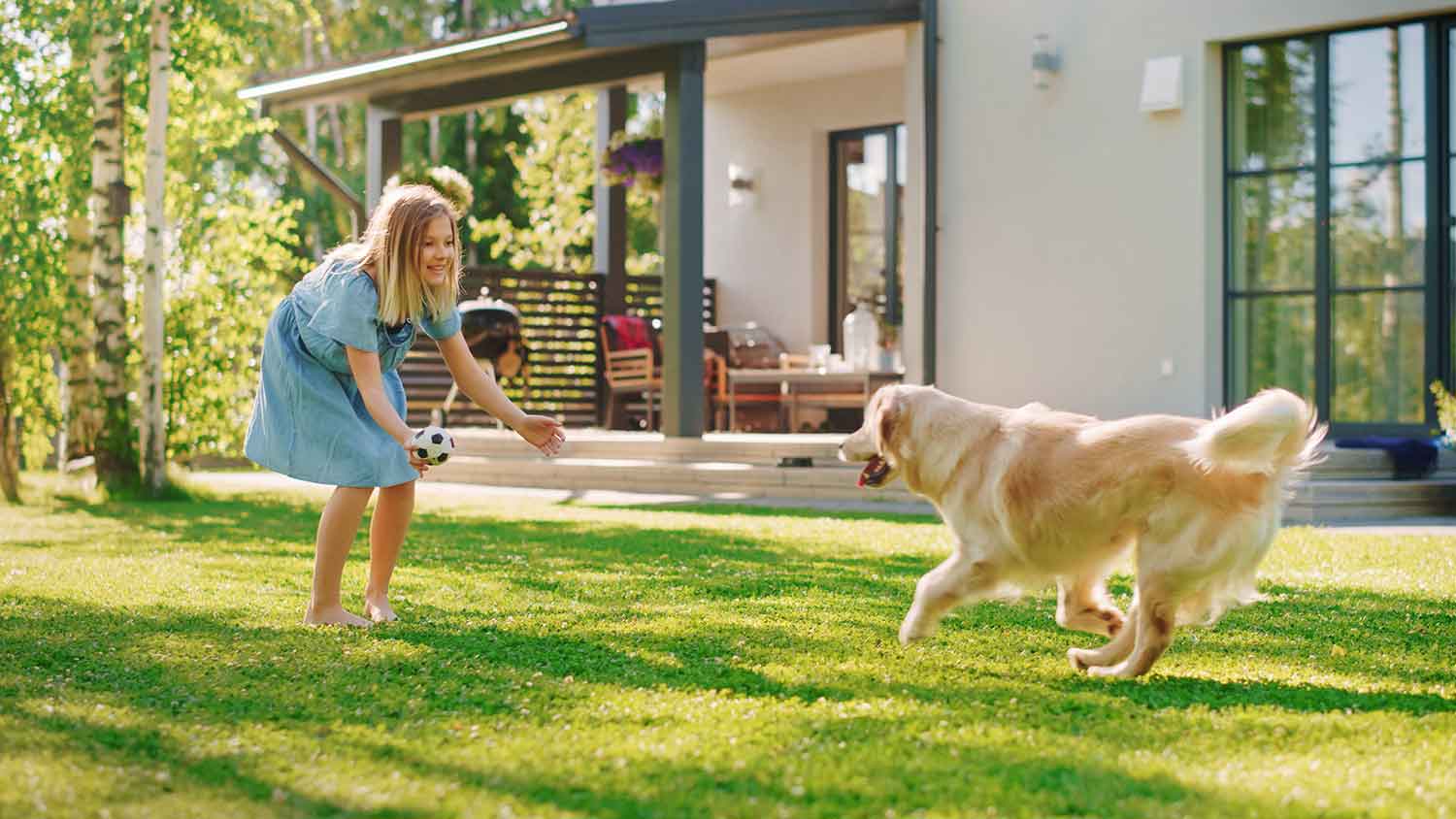 Girl playing with her dog in the backyard