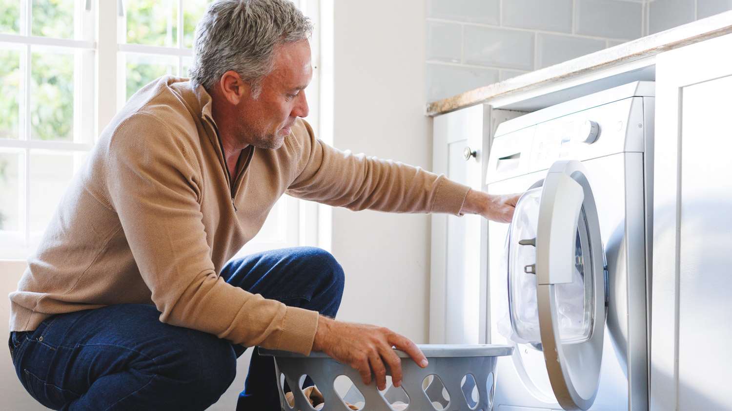 Man with gray hair doing laundry