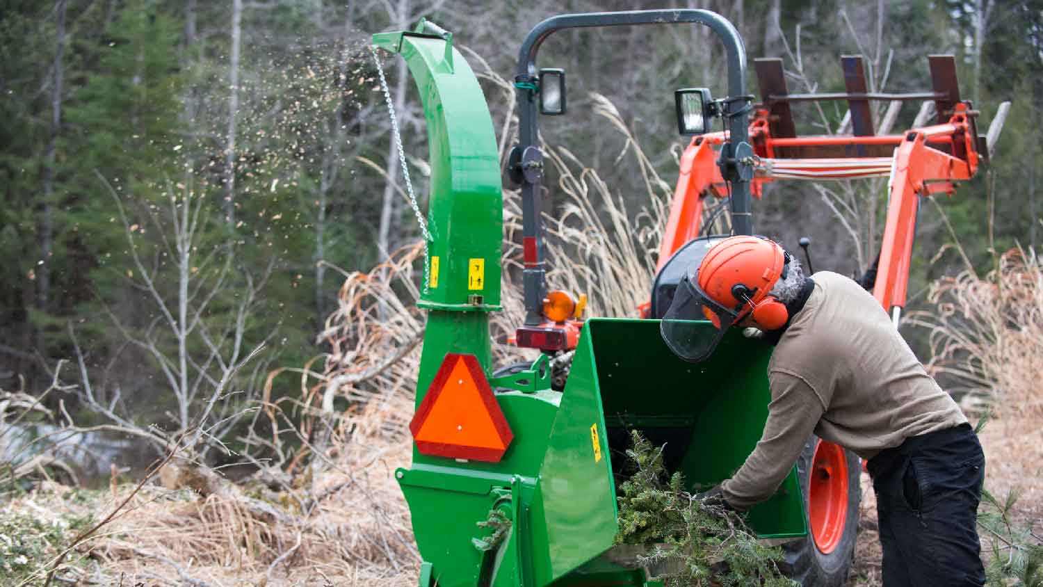 A man using a wood chipper