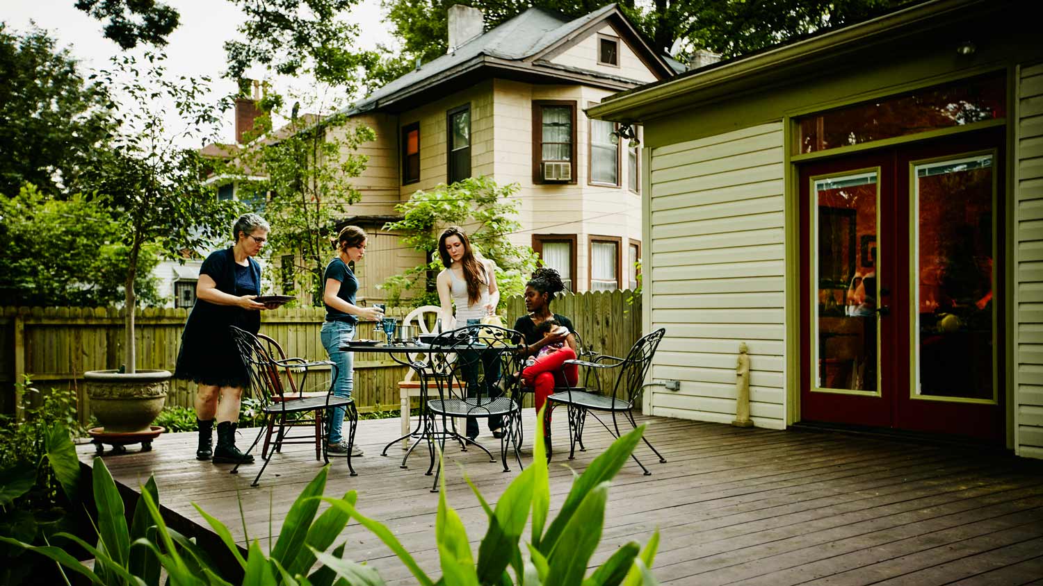 A family clearing a porch table