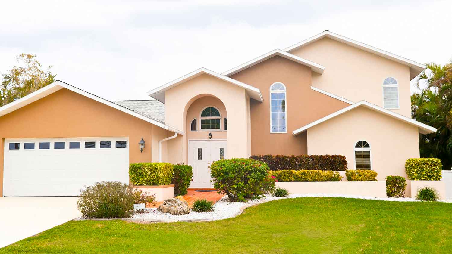 Large stucco house exterior in tan tones