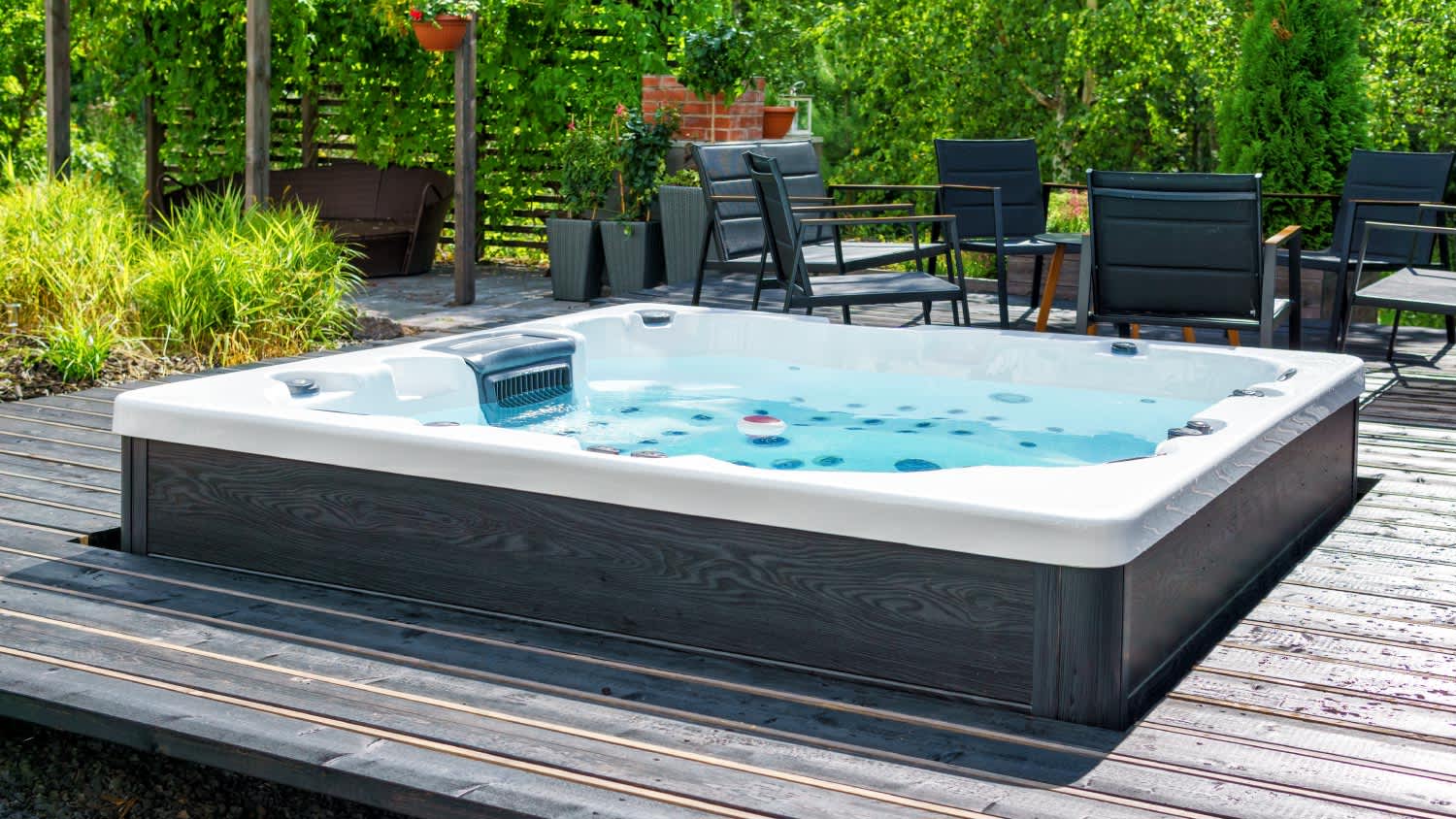 A large hot tub in the backyard terrace