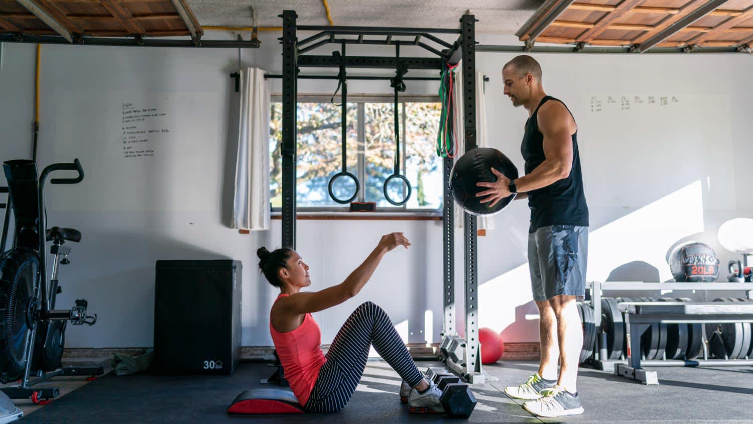 A woman exercising with personal trainer