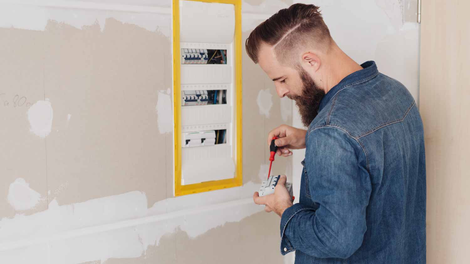 Man installing an electrical panel