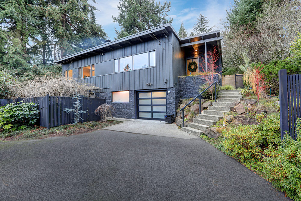 Asphalt driveway leading up to a two-story contemporary home