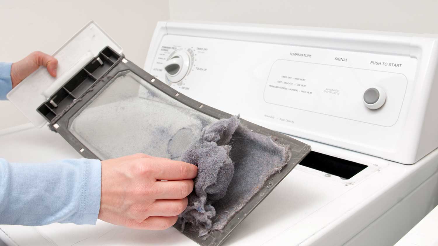 Man removing lint from the dryer filter