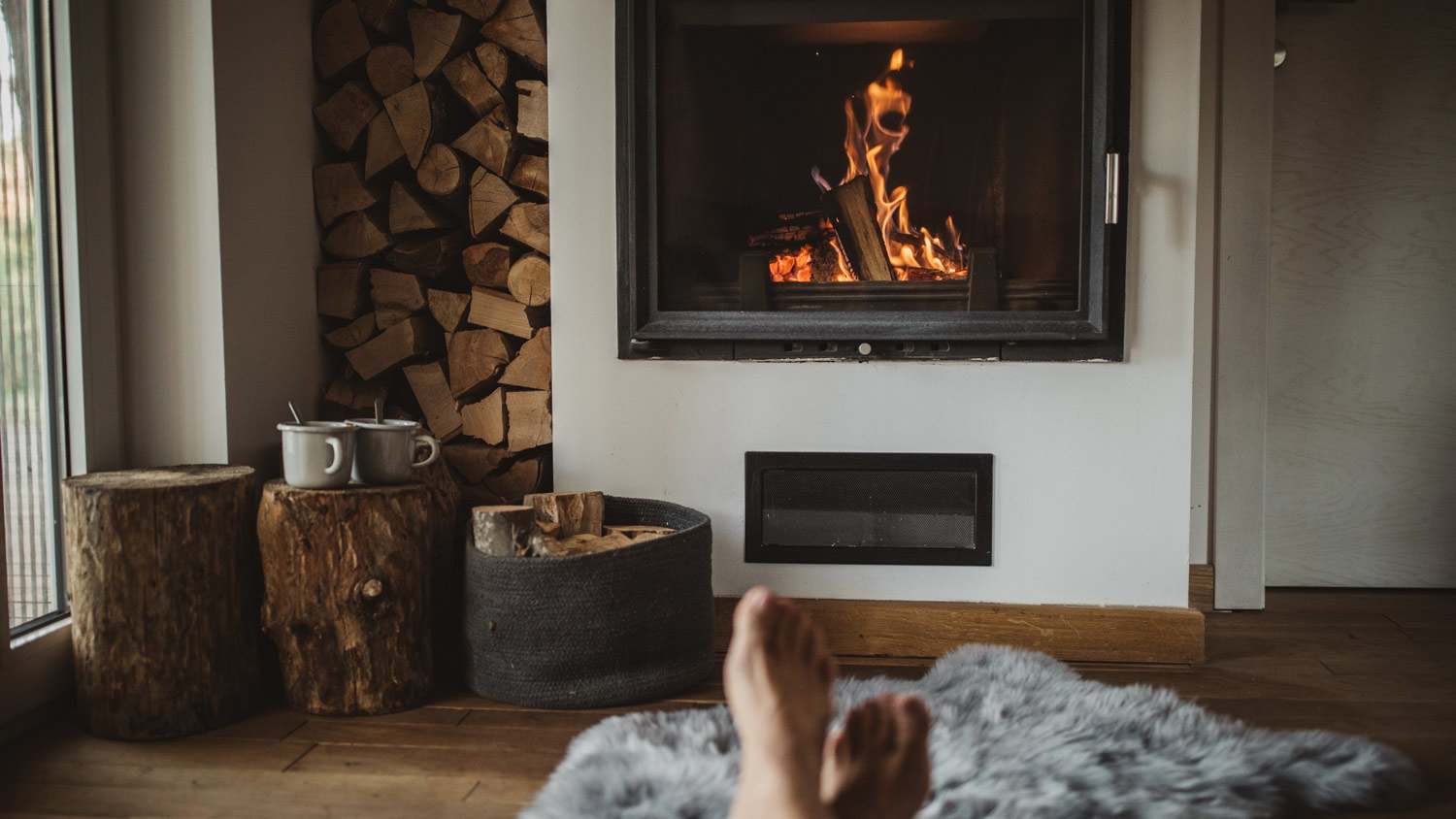 A woman’s feet near her fireplace