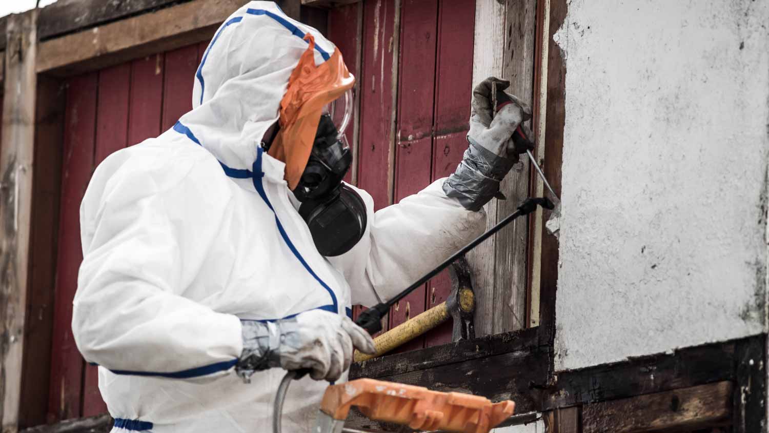 Worker removing asbestos on a construction site