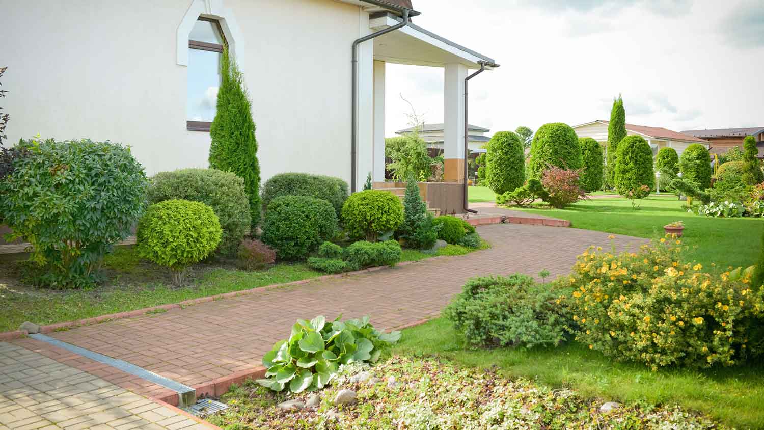 Country house exterior with ornamental bushes