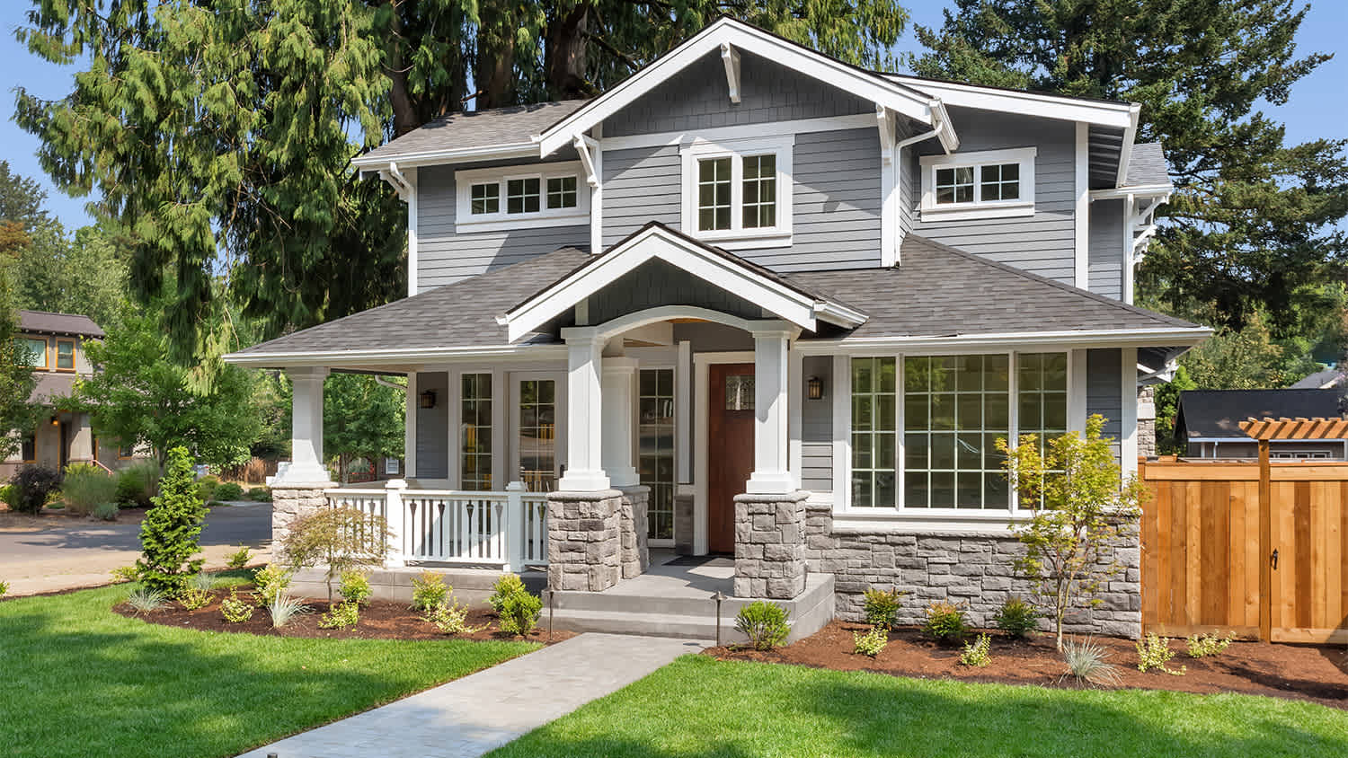 home with covered porch and fresh cut grass