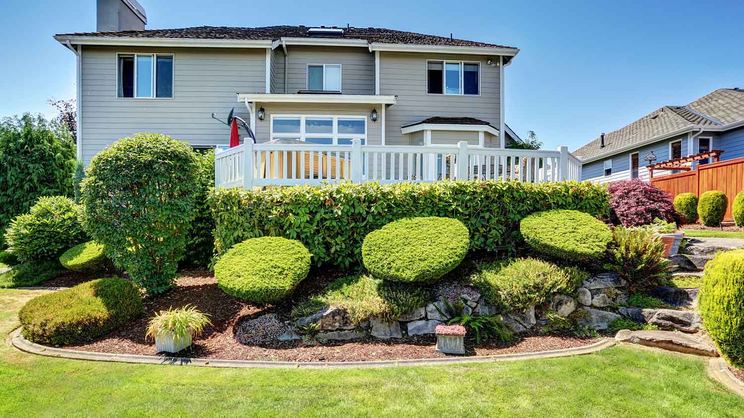 House exterior with deck and bushes