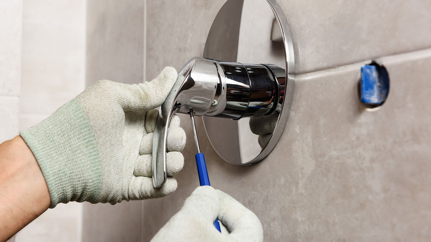 Plumber installing new shower handle