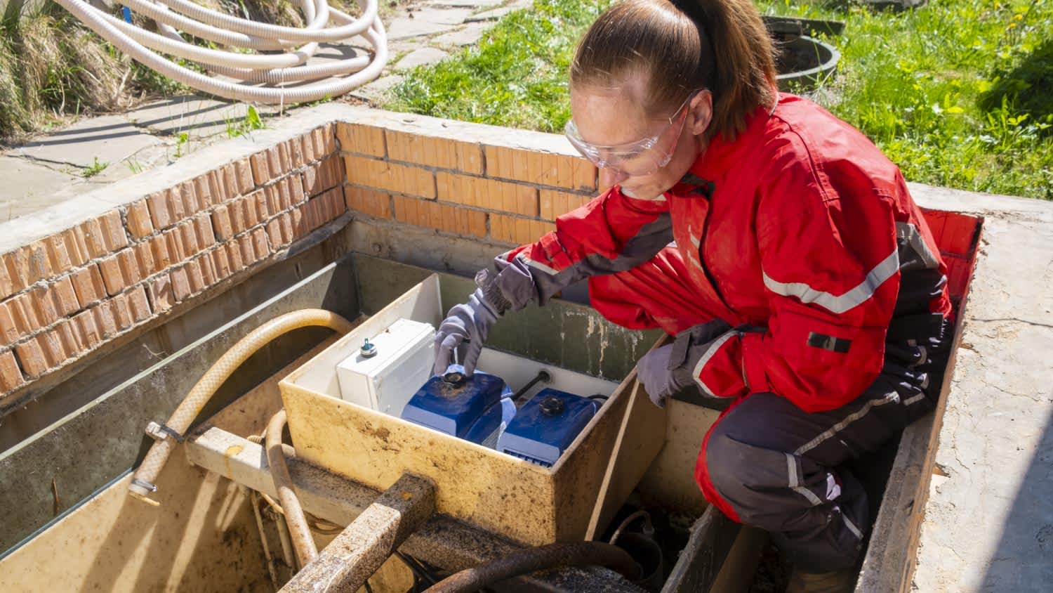 A woman working on a septic system