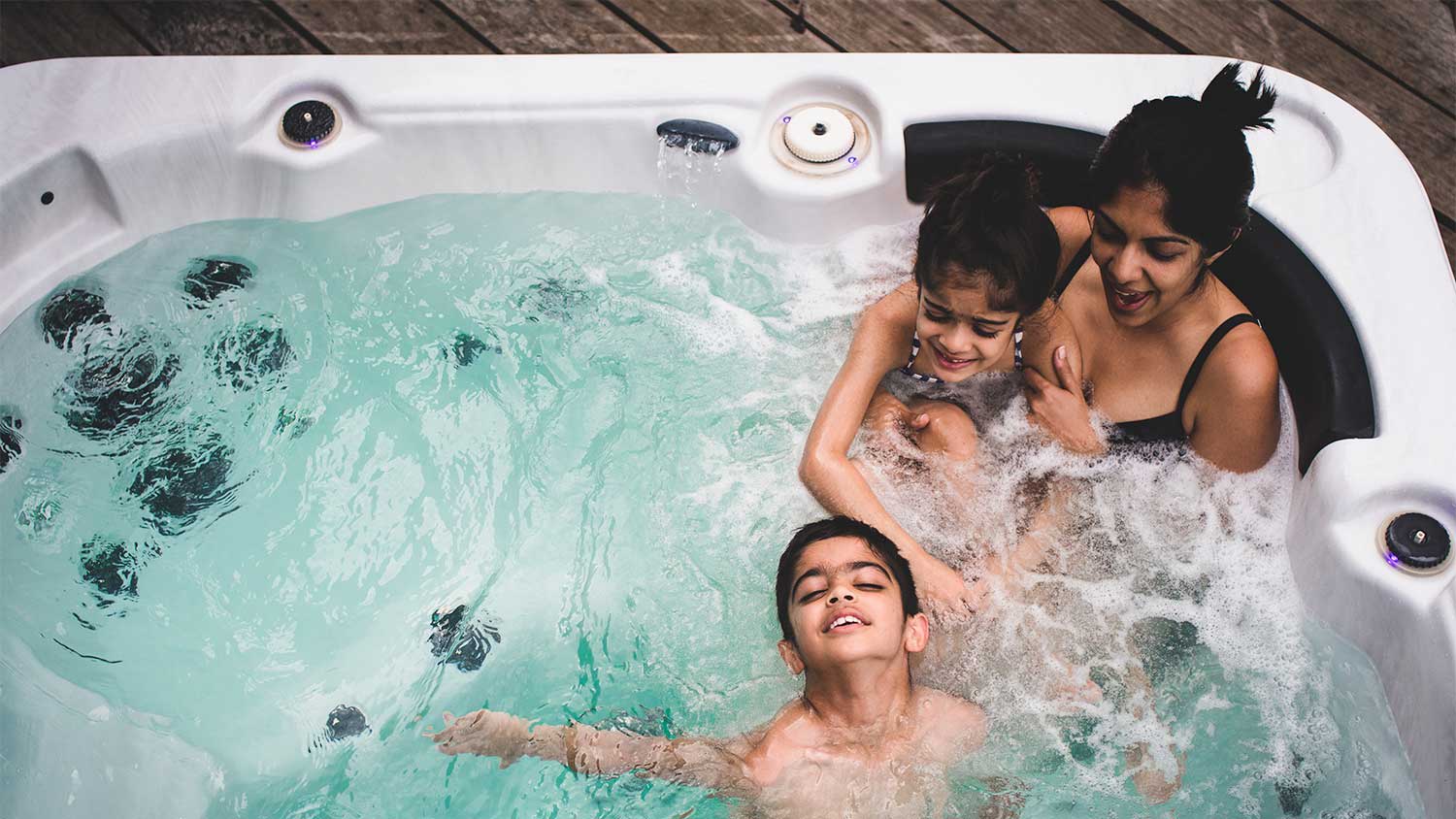 A family relaxes in a hot tub