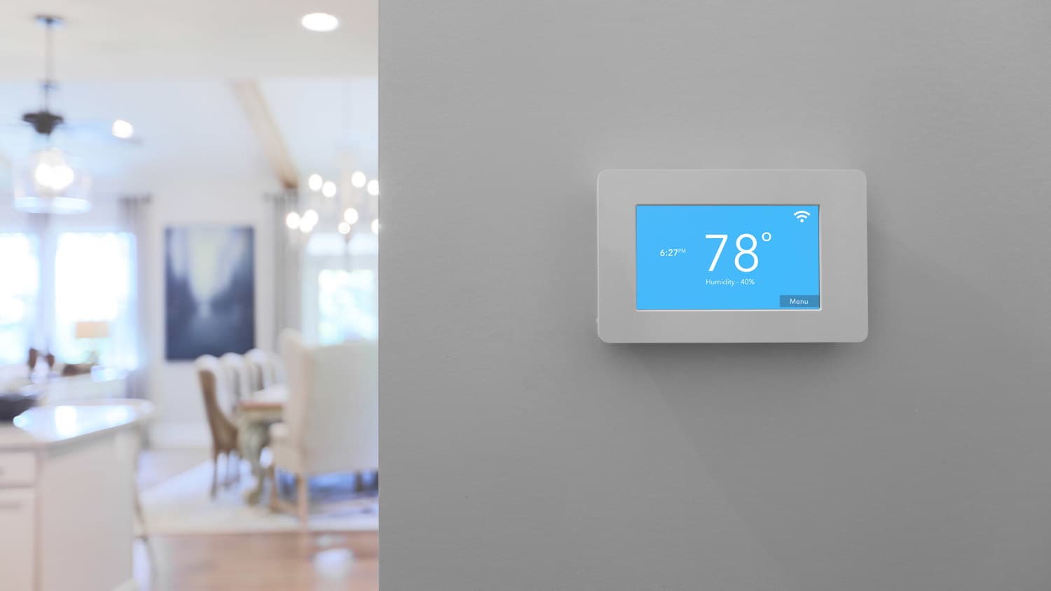 house smart thermostat mounted on wall