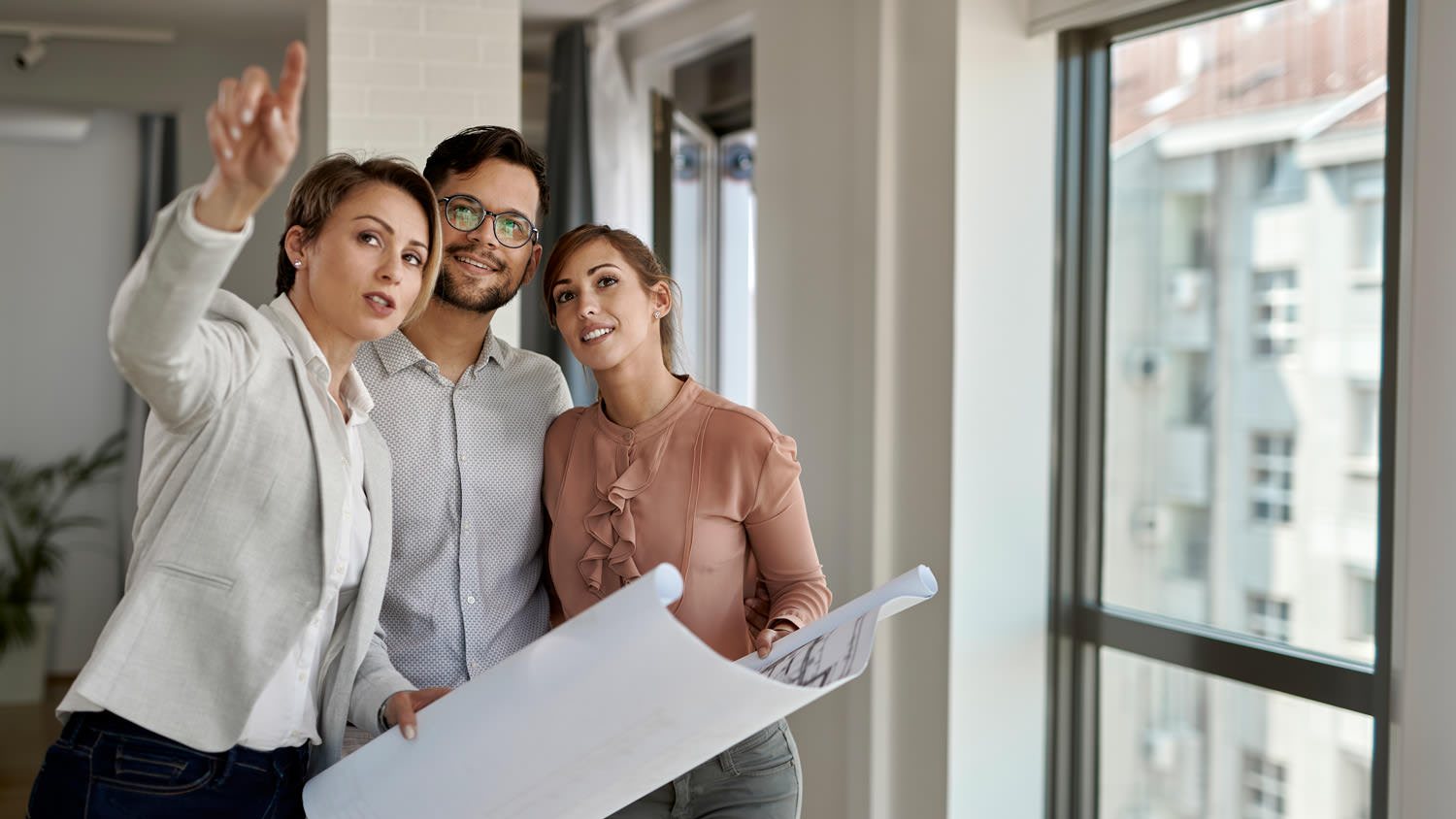 A young couple getting an estimate from a contractor