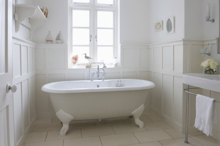 white freestanding bathtub in white bathroom