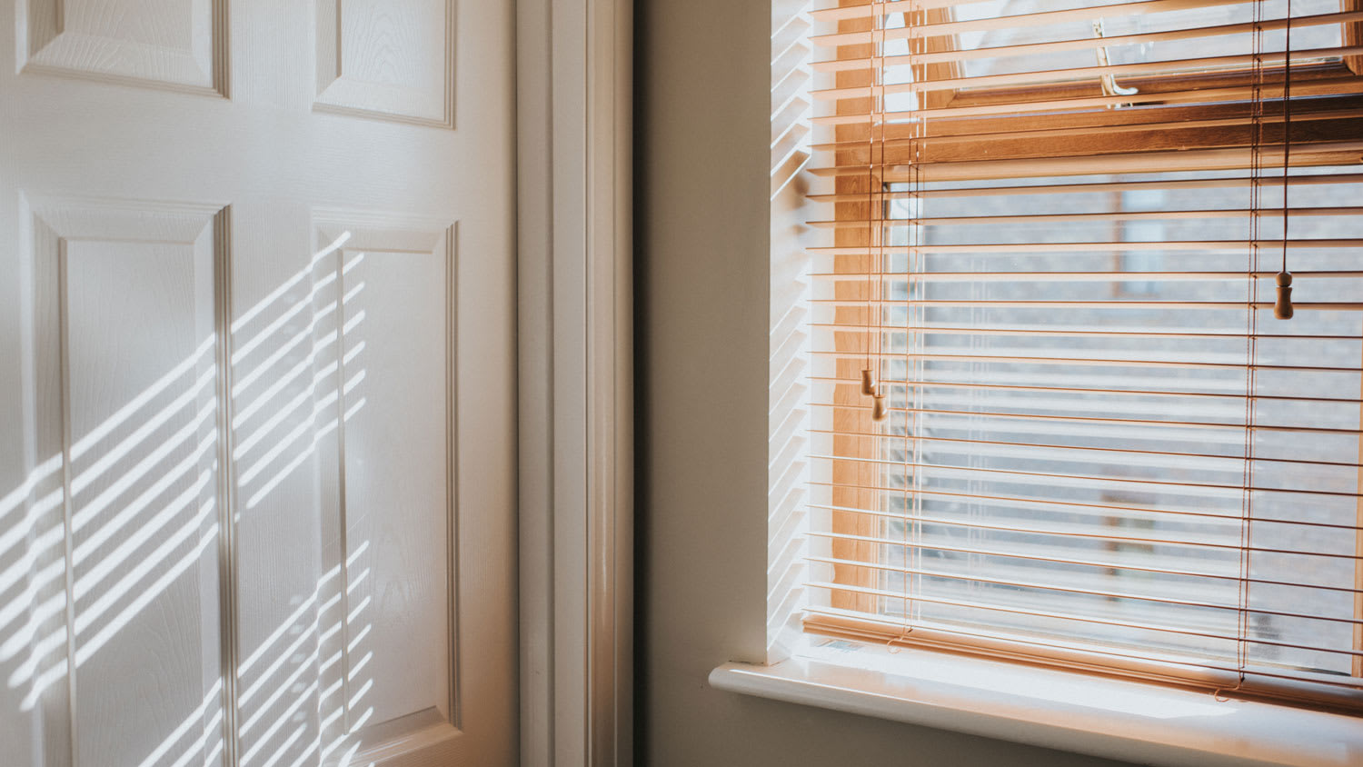 A sunlit window with wooden blinds