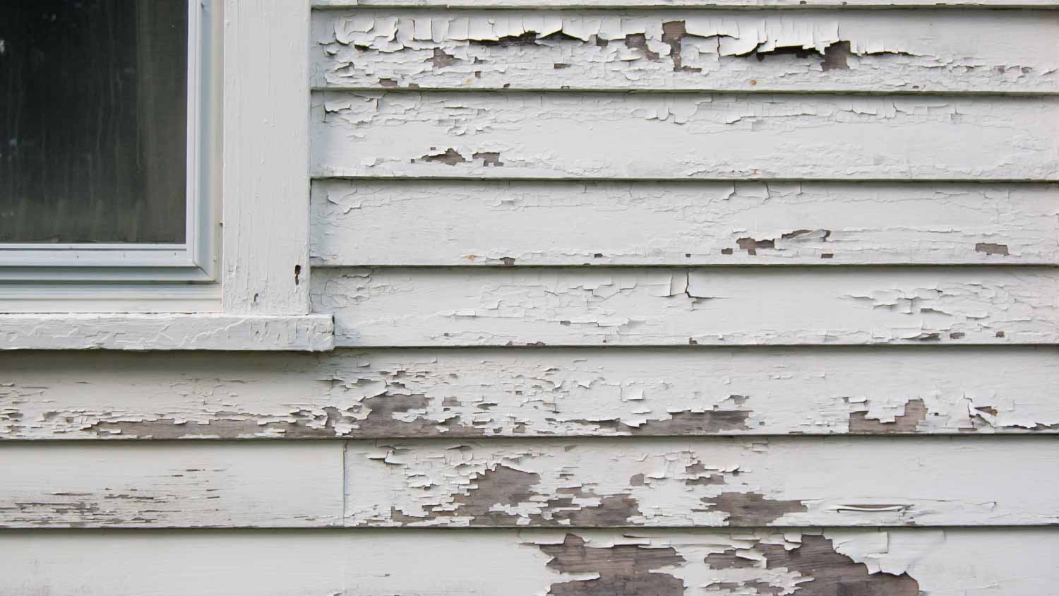 Peeling white paint on siding