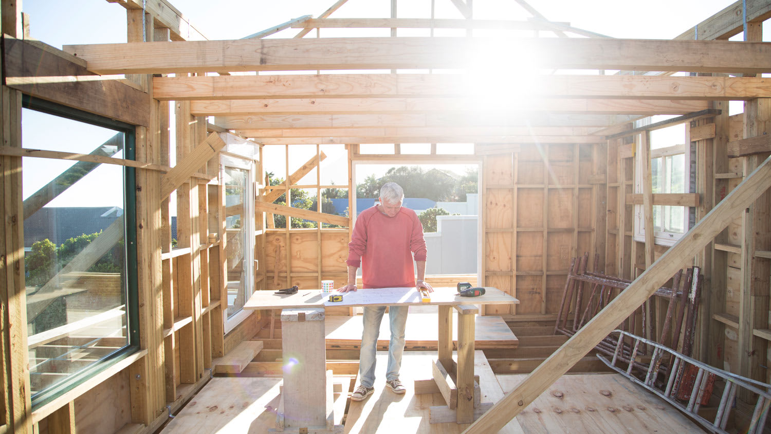 Builder working on a wood framed house