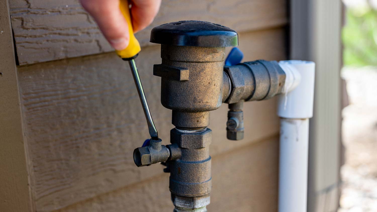 A person assembling a sprinkler valve
