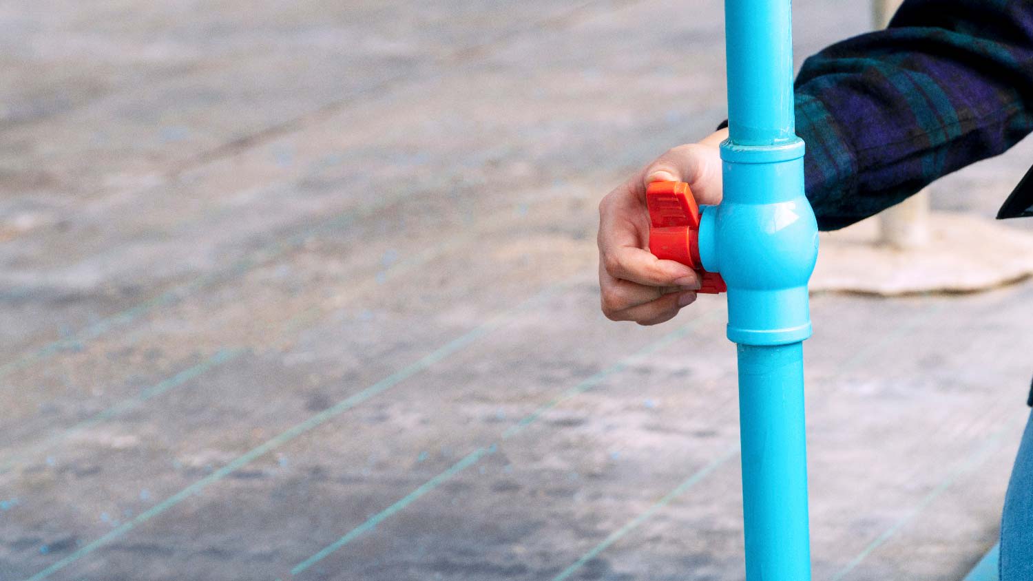 A person turning off the water supply