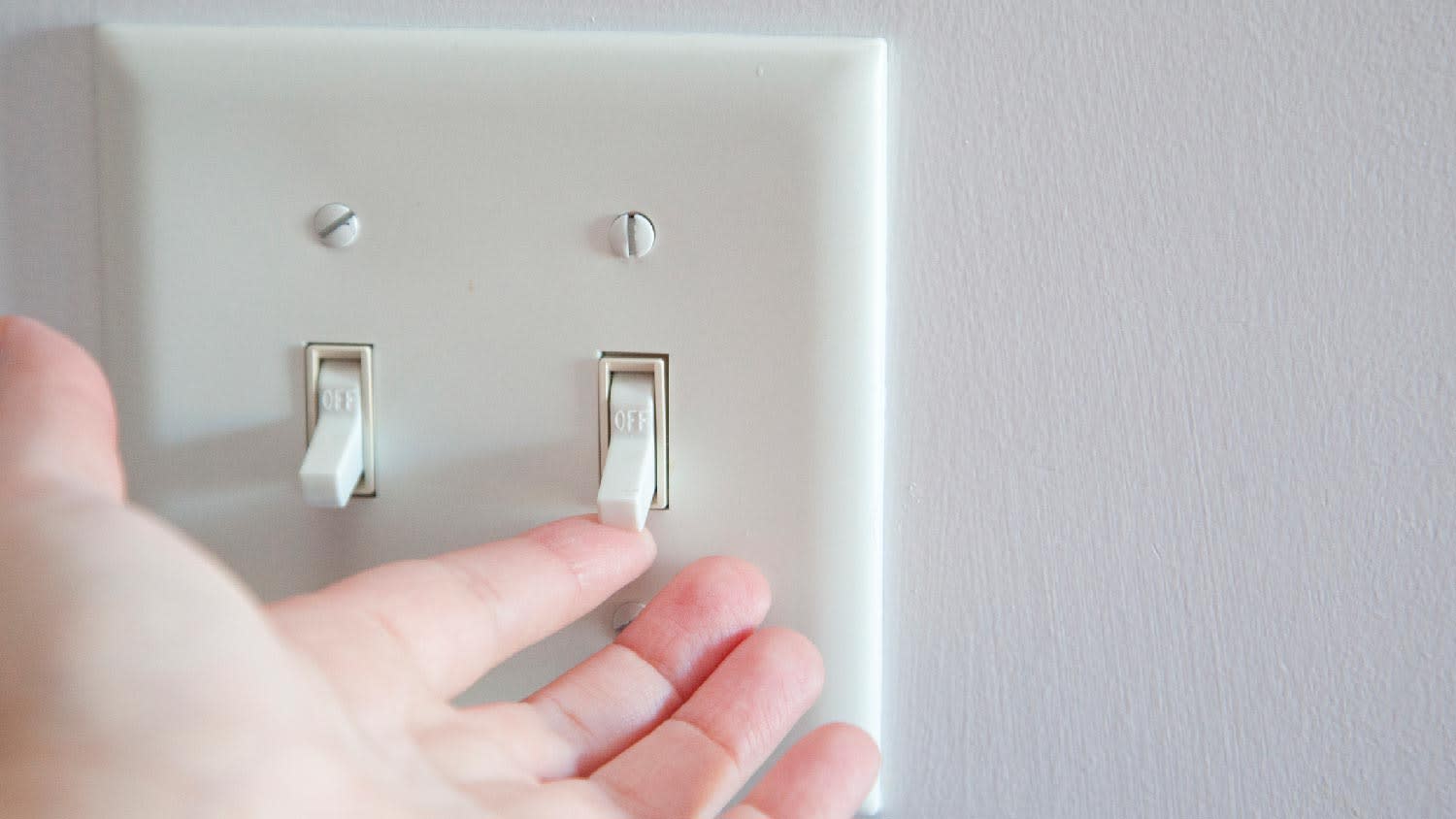 A woman turning on the light