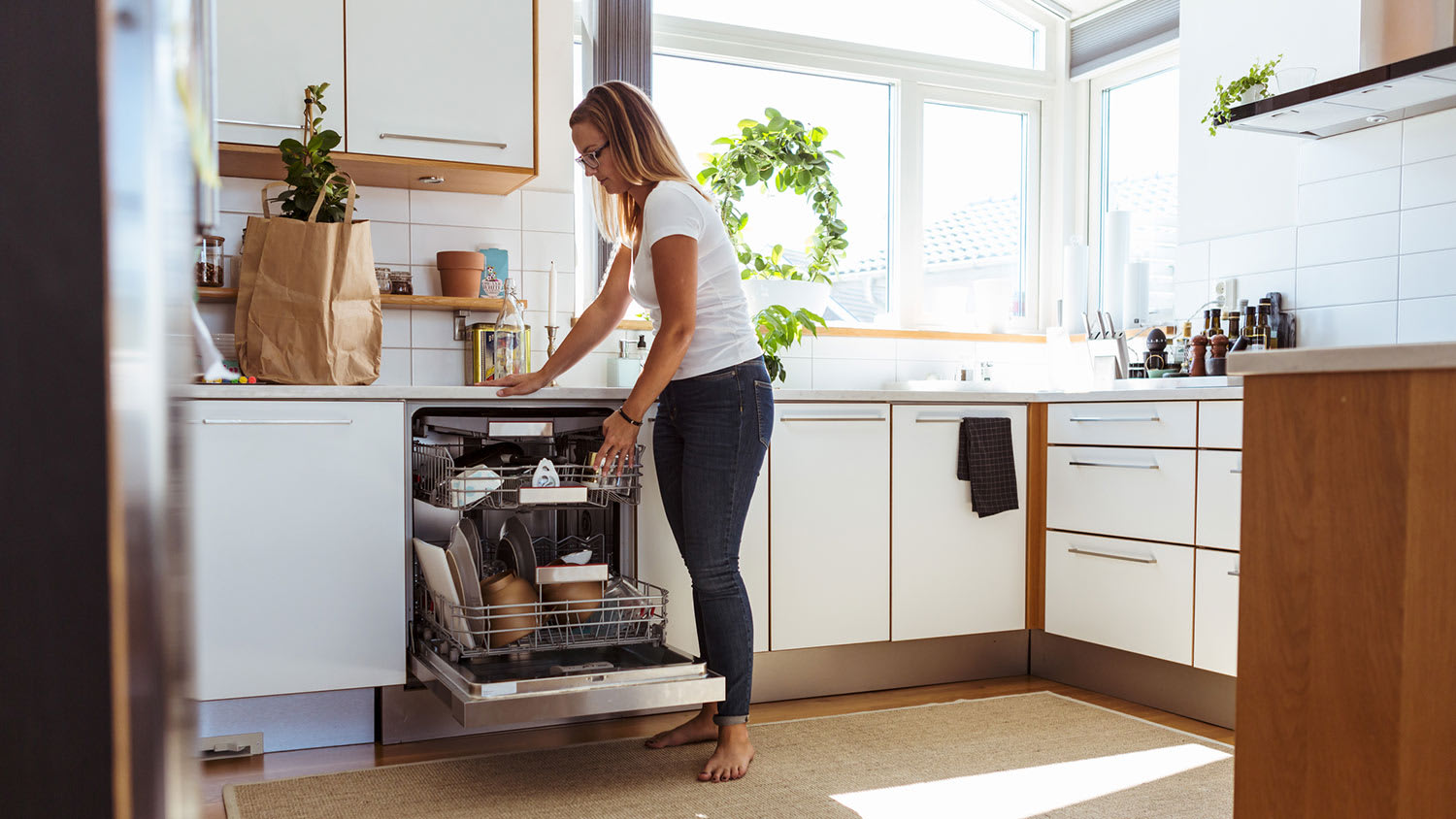 Woman unloading dishwasher