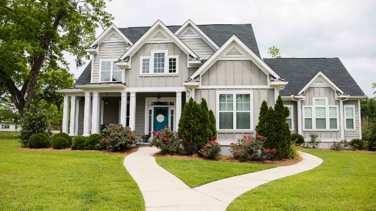 A house with a front yard with bushes