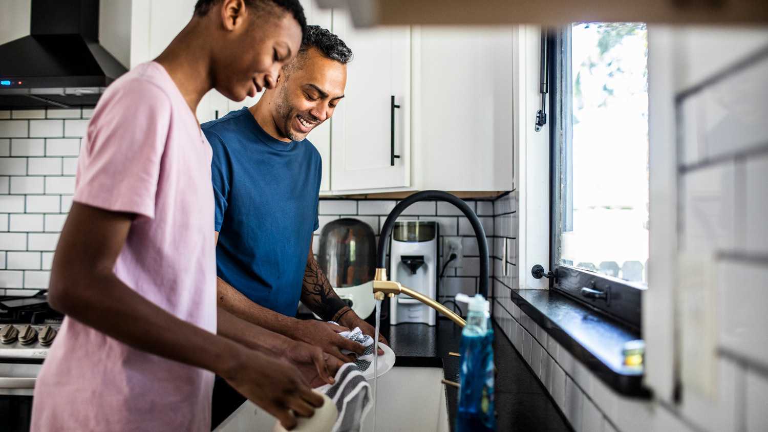 A father with his son washing the dishes