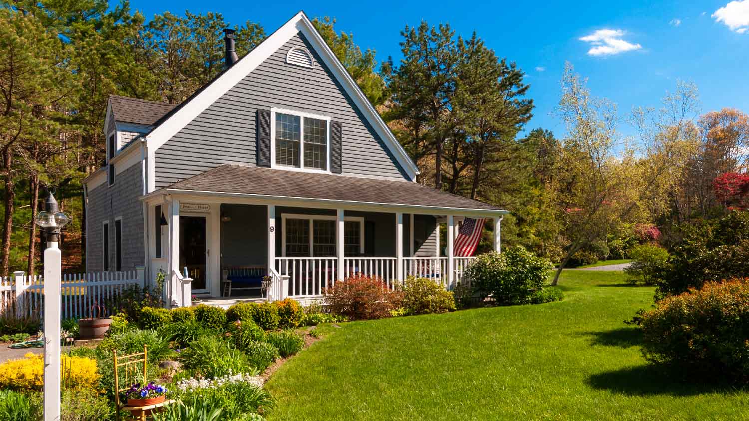 A front yard of a house with bushes