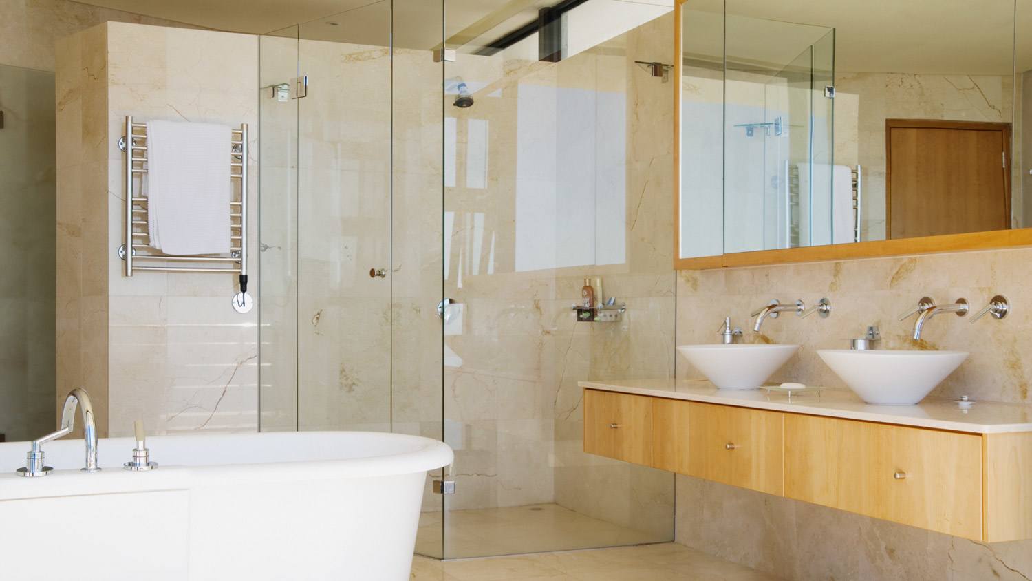A modern large bathroom with a framed glass shower door