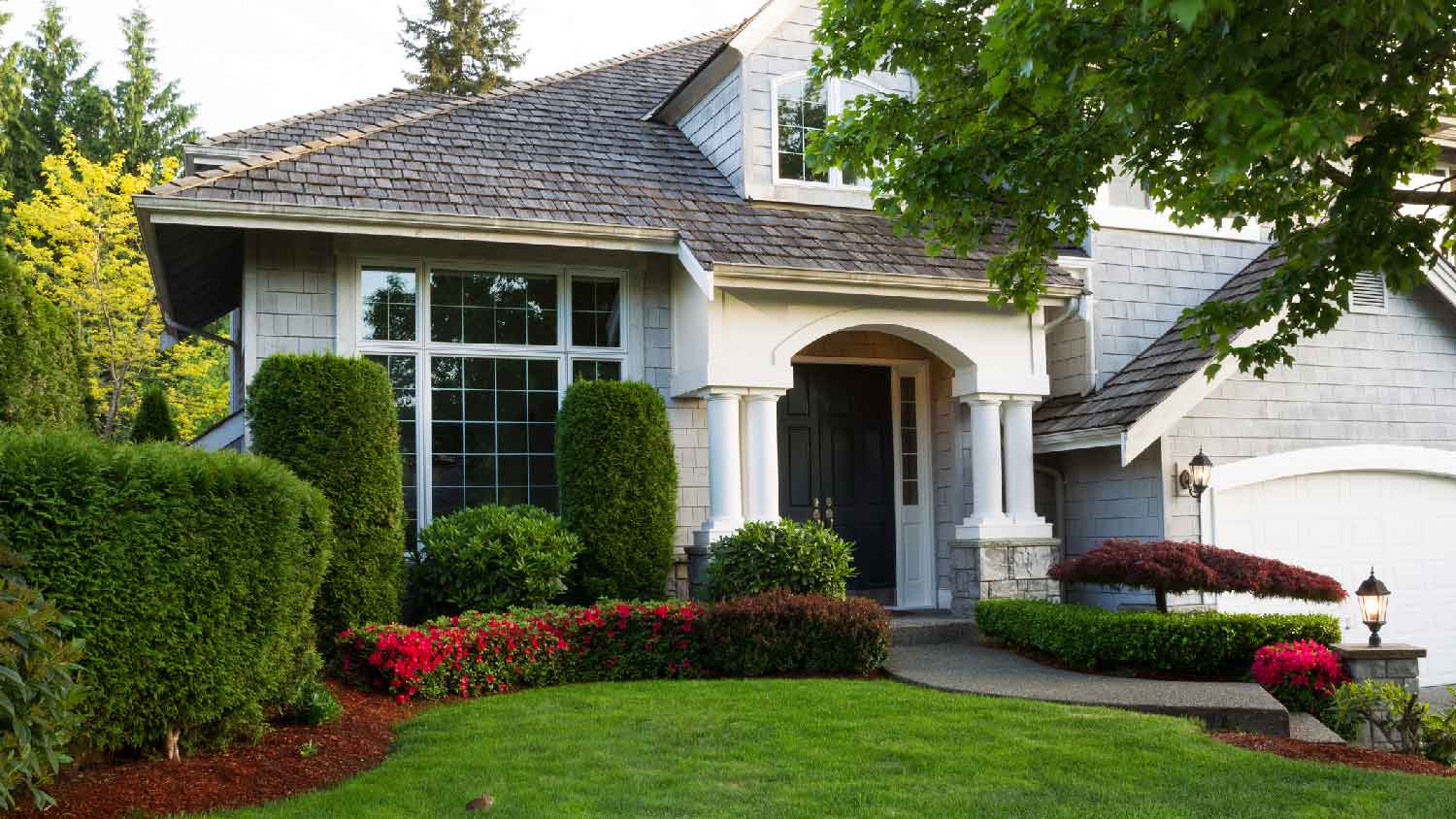A house with beautifully trimmed shrubs