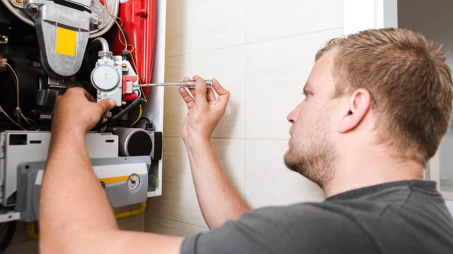 A technician installing a new gas furnace