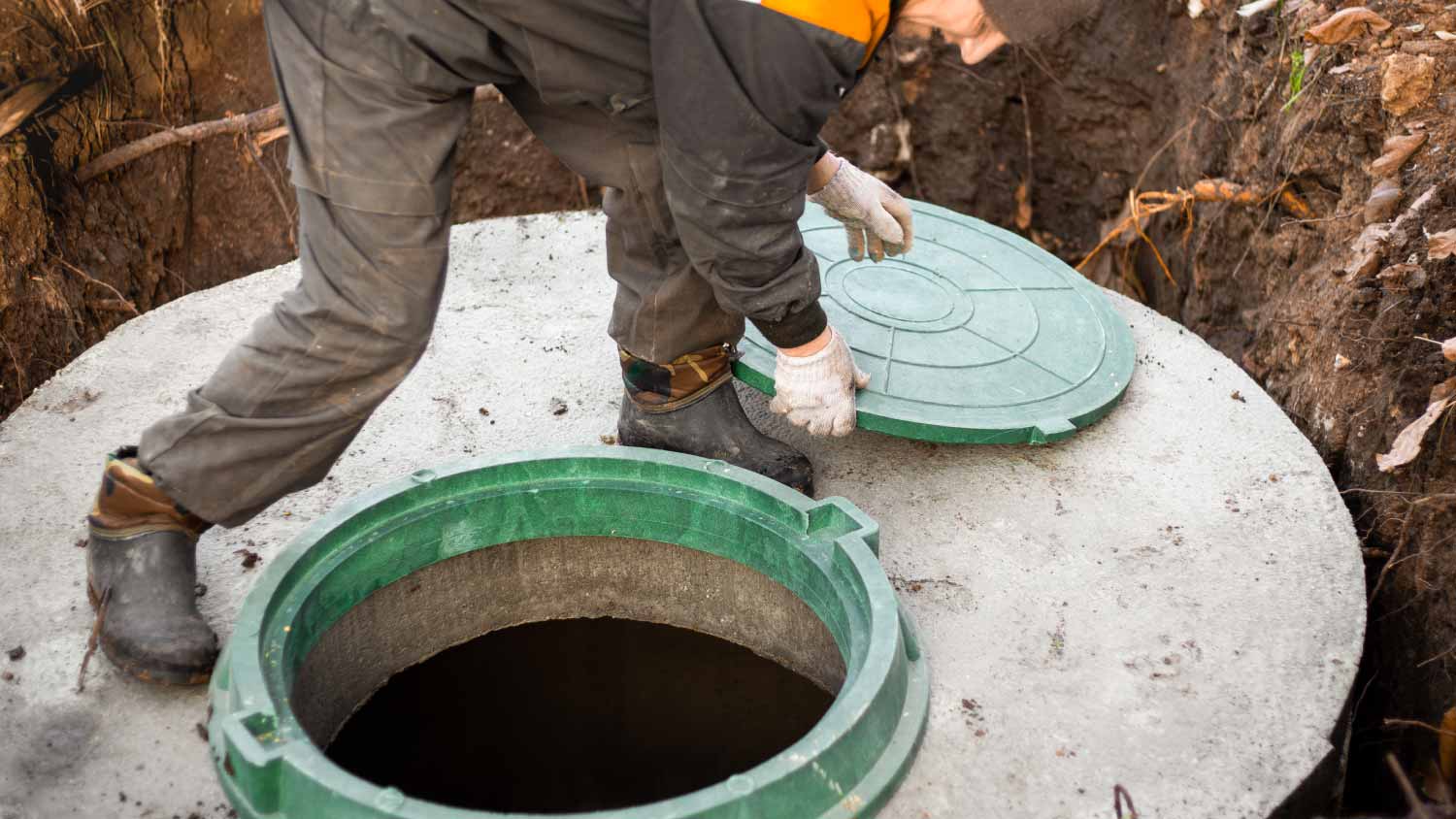 Worker opening cesspool