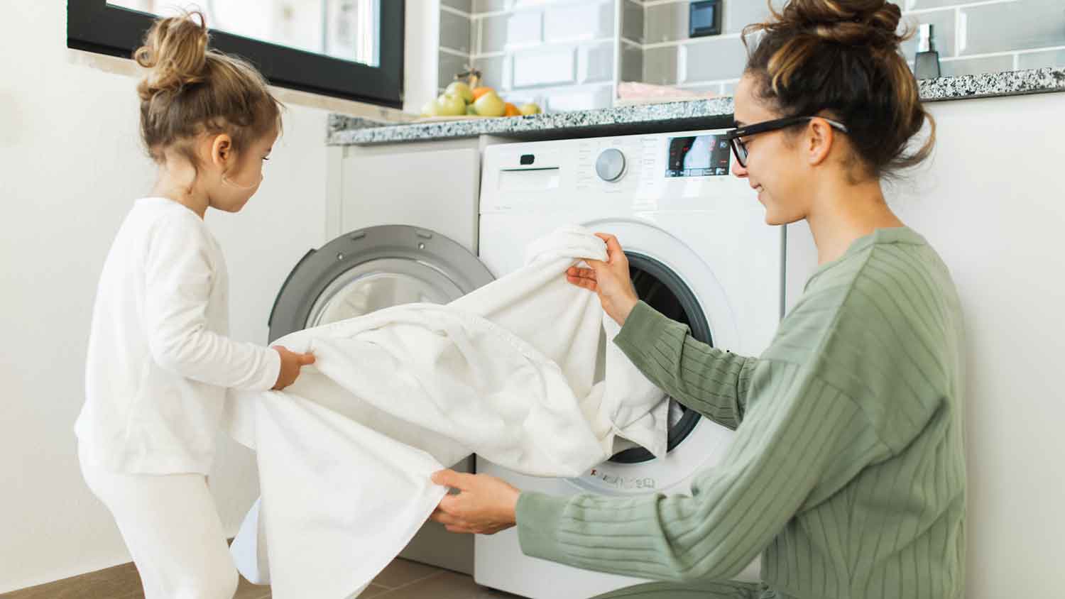 Daughter helping mom with the laundry