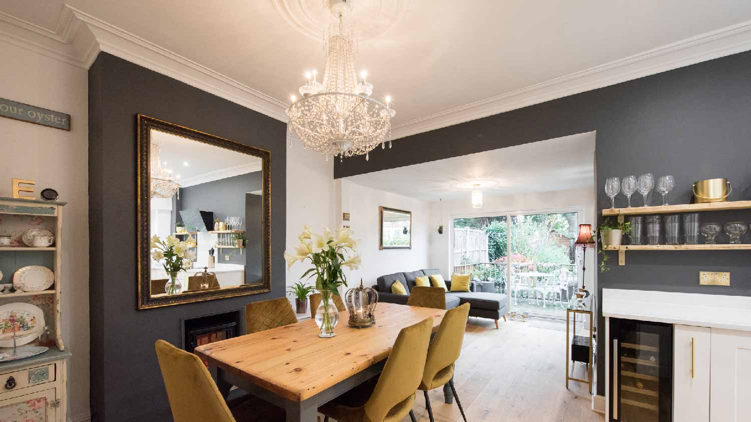 A dining room with a chandelier above the table