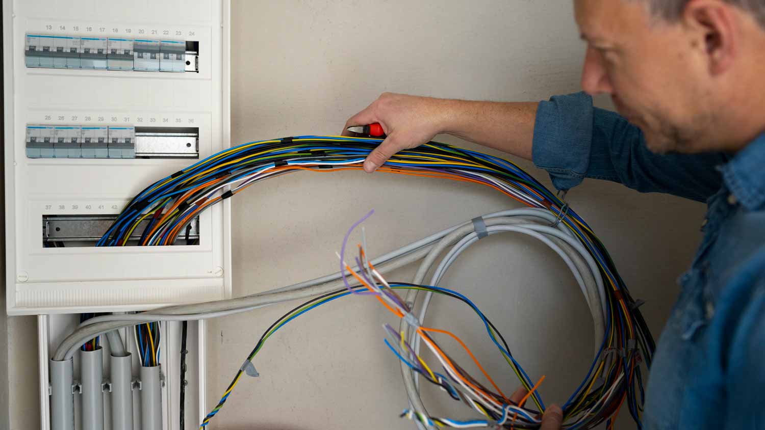 electrician installing wires throughout home