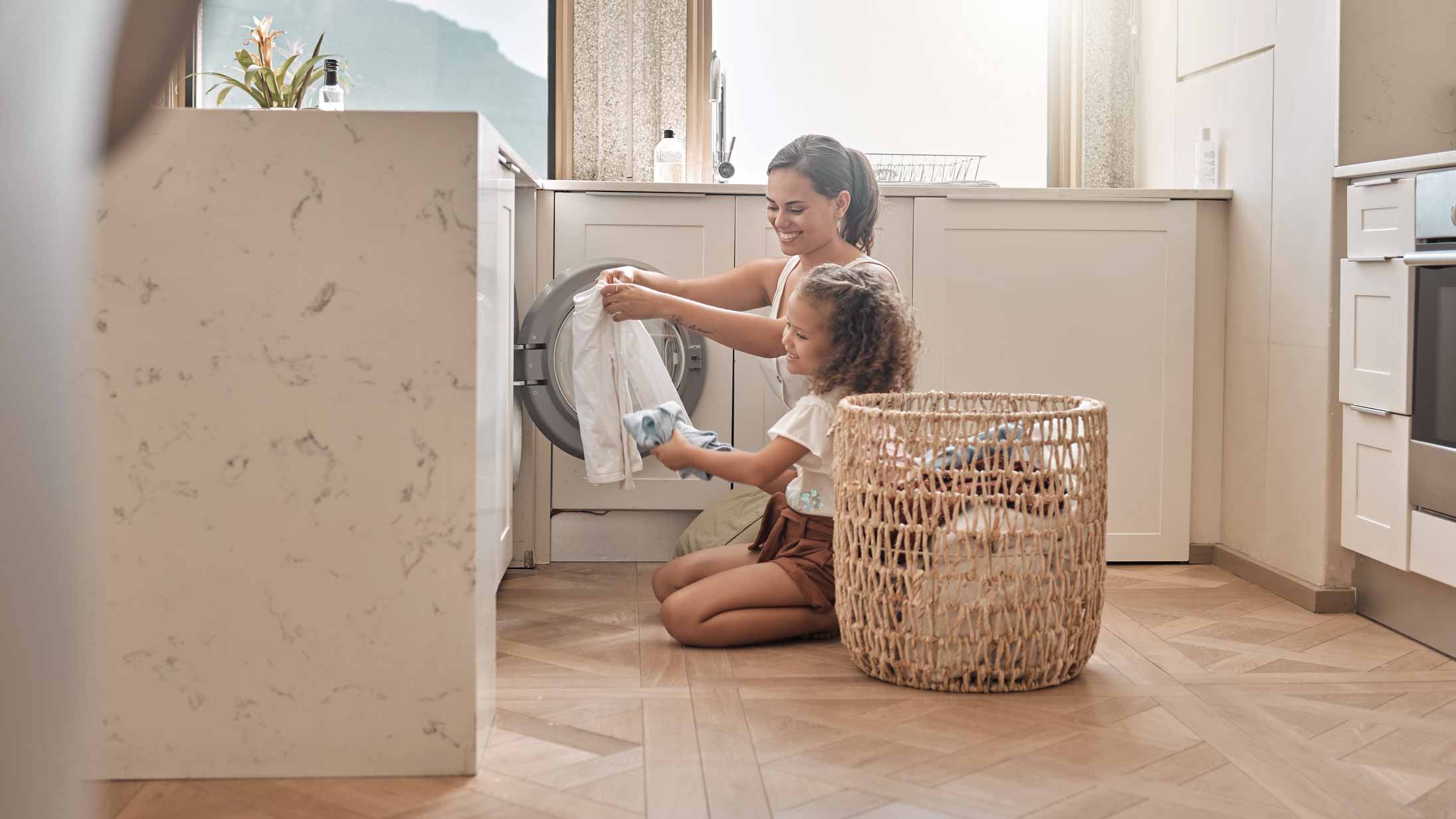 A mother doing the laundry with her daughter